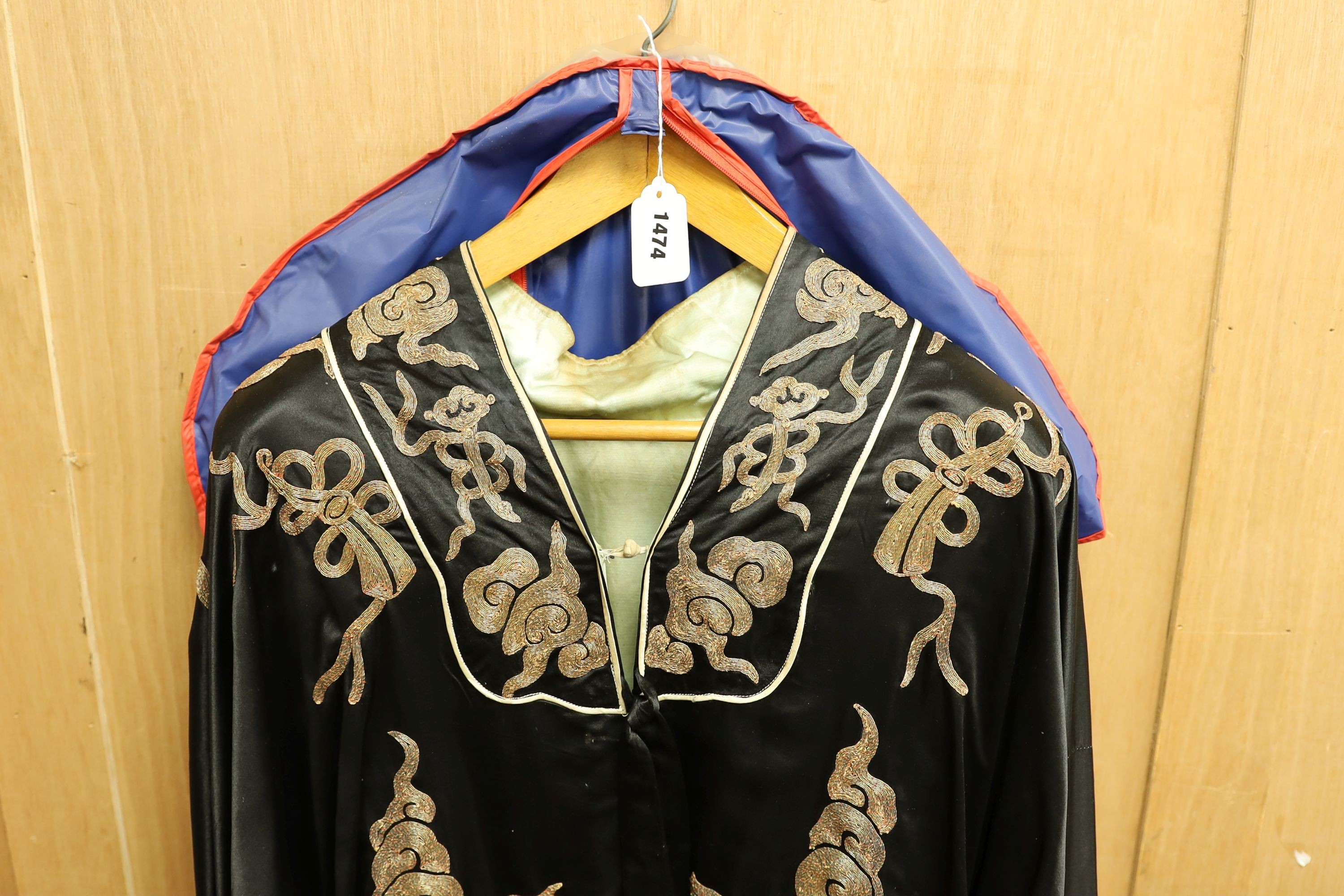 A Chinese black silk and silver thread robe, 44cm across shoulders